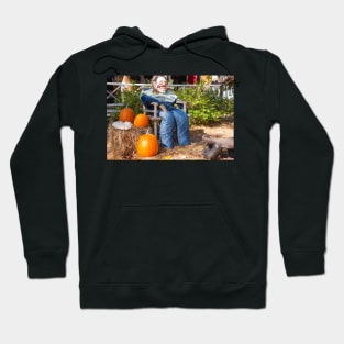 Halloween Mannequin in with ugly mask chair outside beside three large orange pumpkins Hoodie